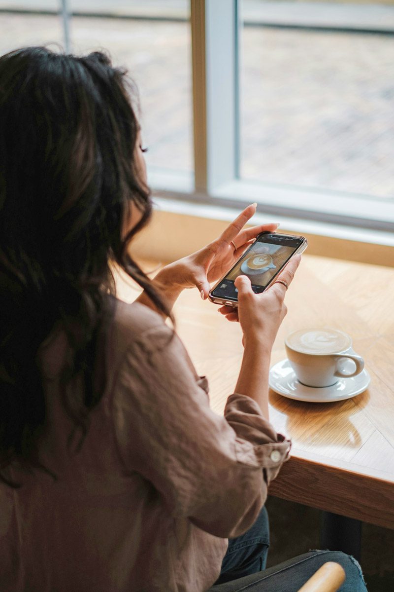 Woman researching coffee roasters for gourmet coffee